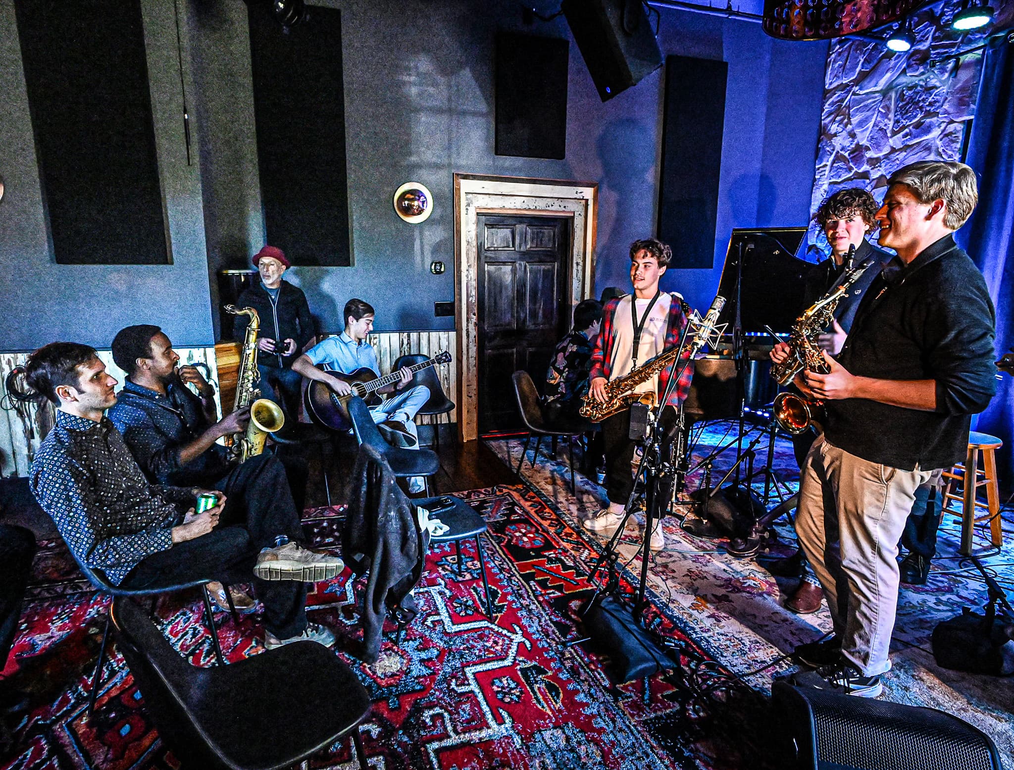 Young musicians jamming together with saxophones and guitar